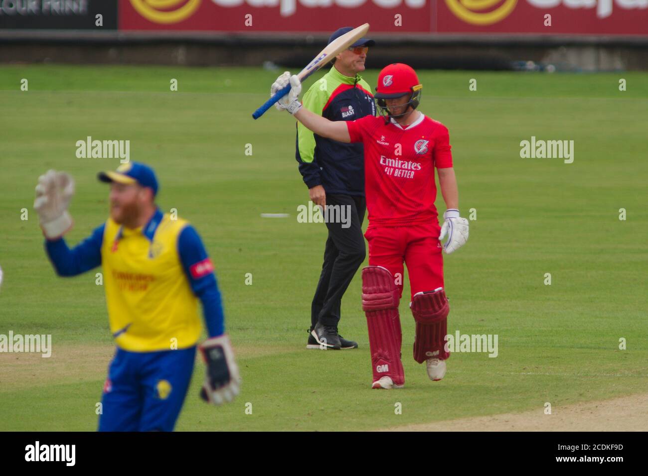 Chester le Street, England, 27 August 2020. Alex Davies of Lancashire Lightning raising his bat to celebrate reaching 50 runs against Durham Cricket in their Vitality Blast fixture at the Riverside Ground. Stock Photo