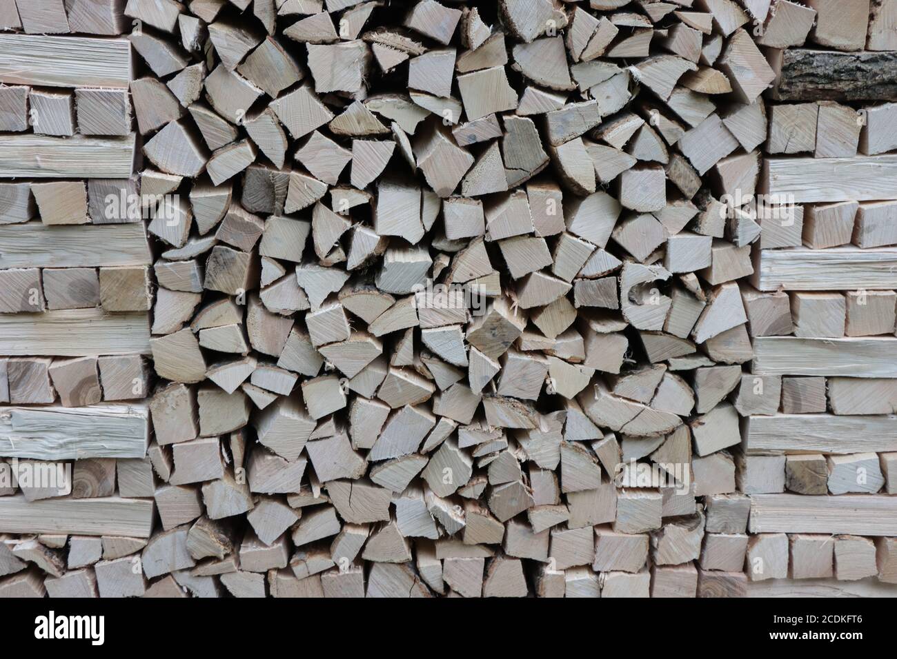 A pile of logs in front of a house. Stock Photo