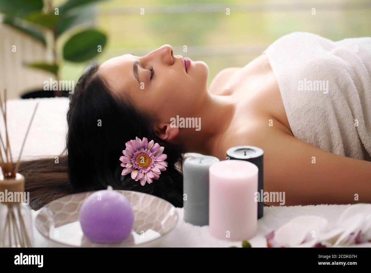 Relaxed Woman Lying In Spa Salon With Closed Eyes Waiting For Massage