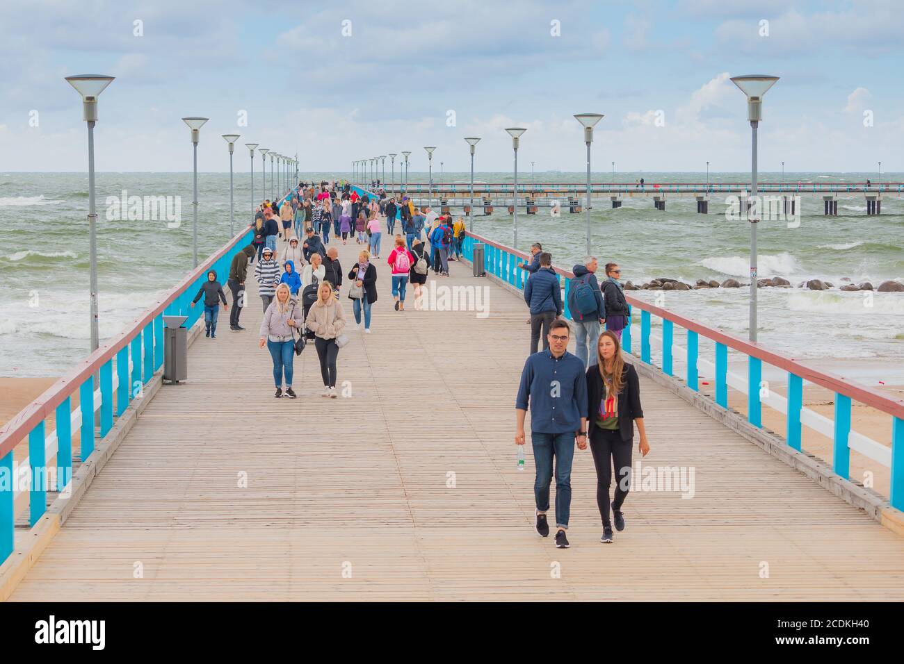 Palanga, Lithuania - August 28 2020: People are walking on a pier bridge. Cloudy day in a city Palanga Stock Photo