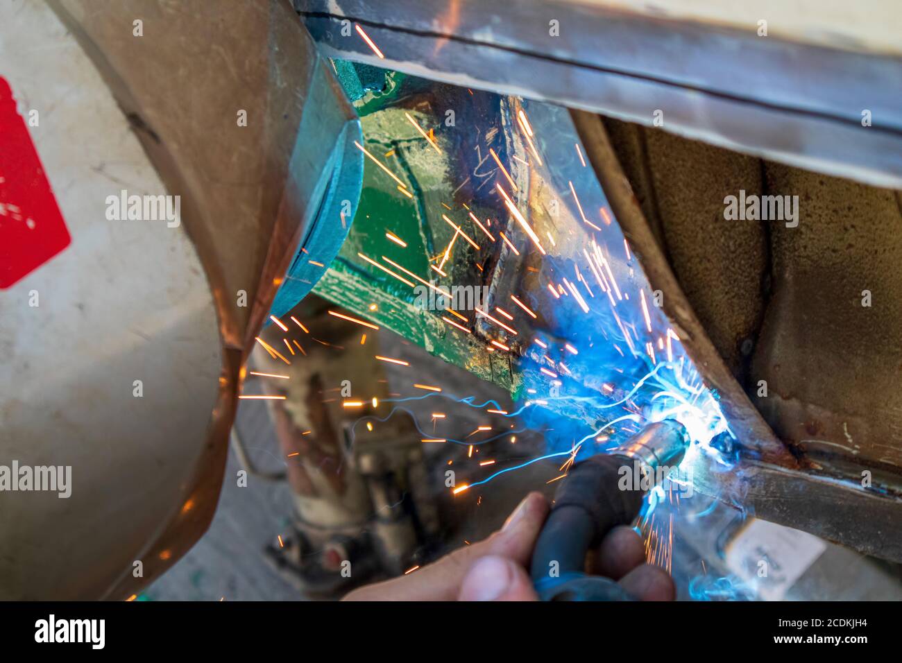 Home electric welding by a semiautomatic device MIG, repairing an old car at home Stock Photo