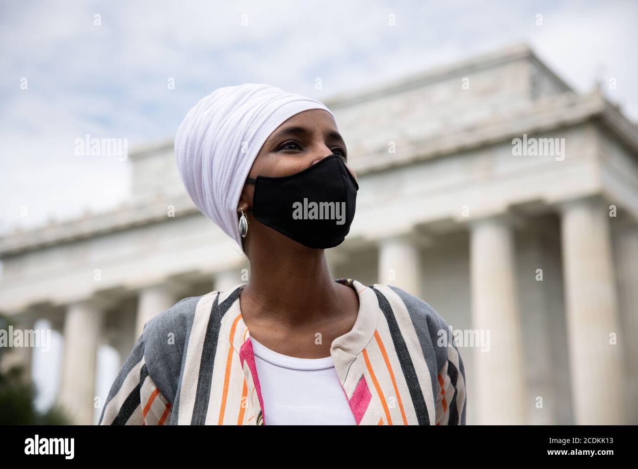Representative Ilhan Omar (D-MN) stands in front of the Lincoln Memorial on the National Mall during the civil rights march organized by Al Sharpton calling attention to systemic racism and police violence after the May police killing of George Floyd in Minnesota, in Washington, DC, on August 28, 2020, amid the coronavirus pandemic. The night before The Commitment March: Get Your Knee Off Our Necks, protests consumed the blocks surrounding the White House, as President Trump gave his presidential nomination acceptance speech with sounds from noisy demonstrations in the background. (Graeme Sl Stock Photo