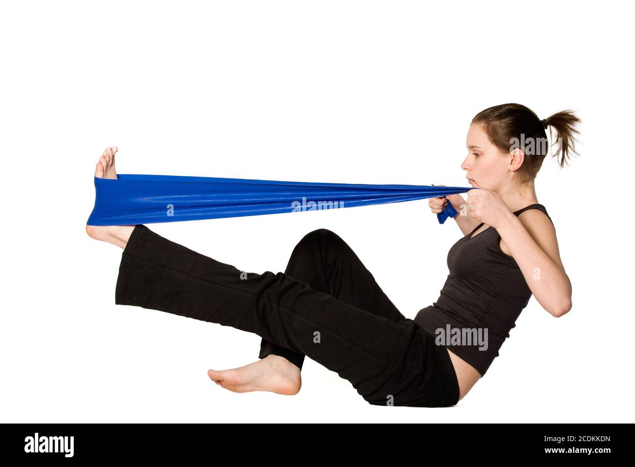 Woman is stretching her leg with a Resistance Band Stock Photo