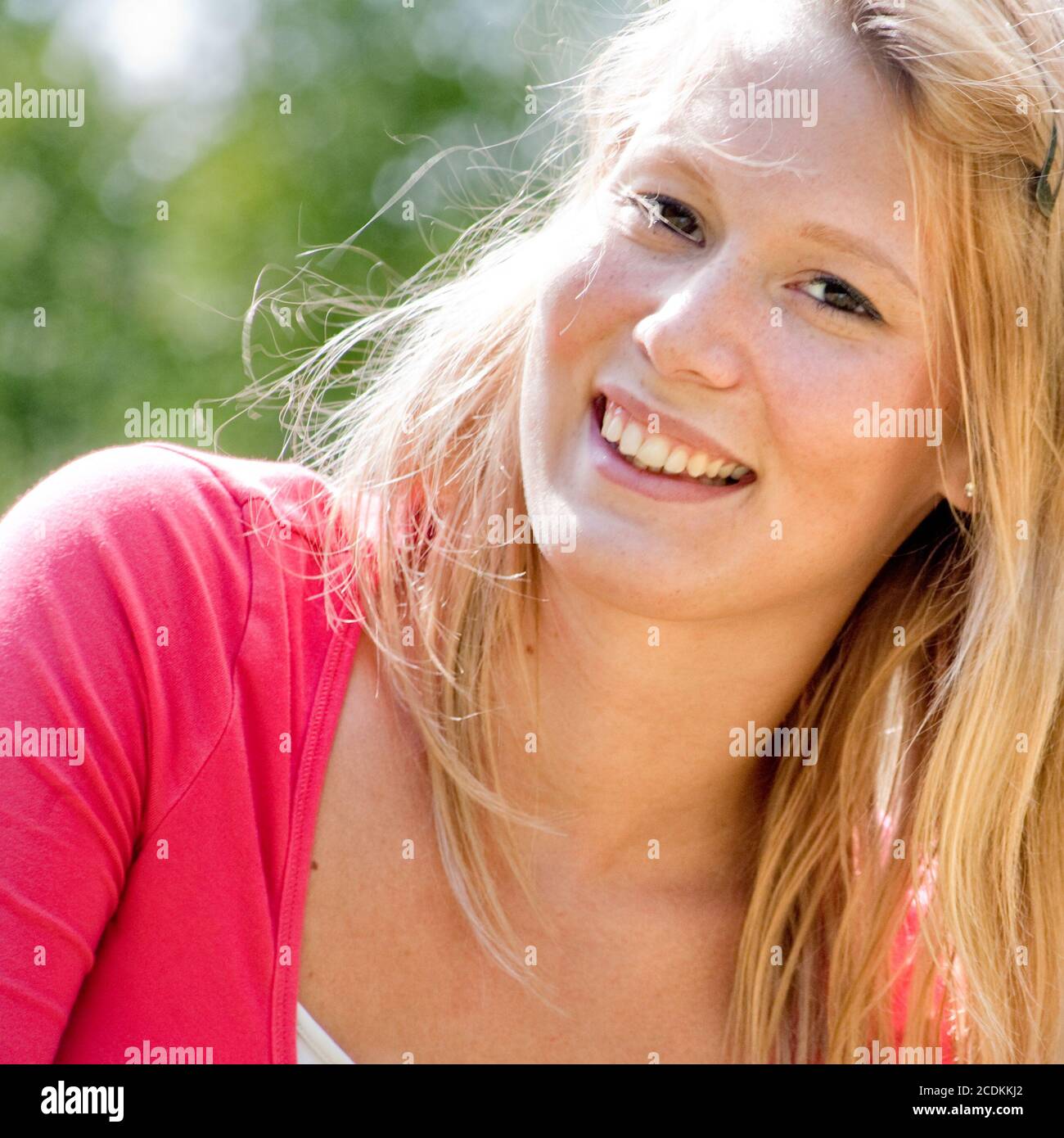 A blond woman in the park with sunny weather Stock Photo