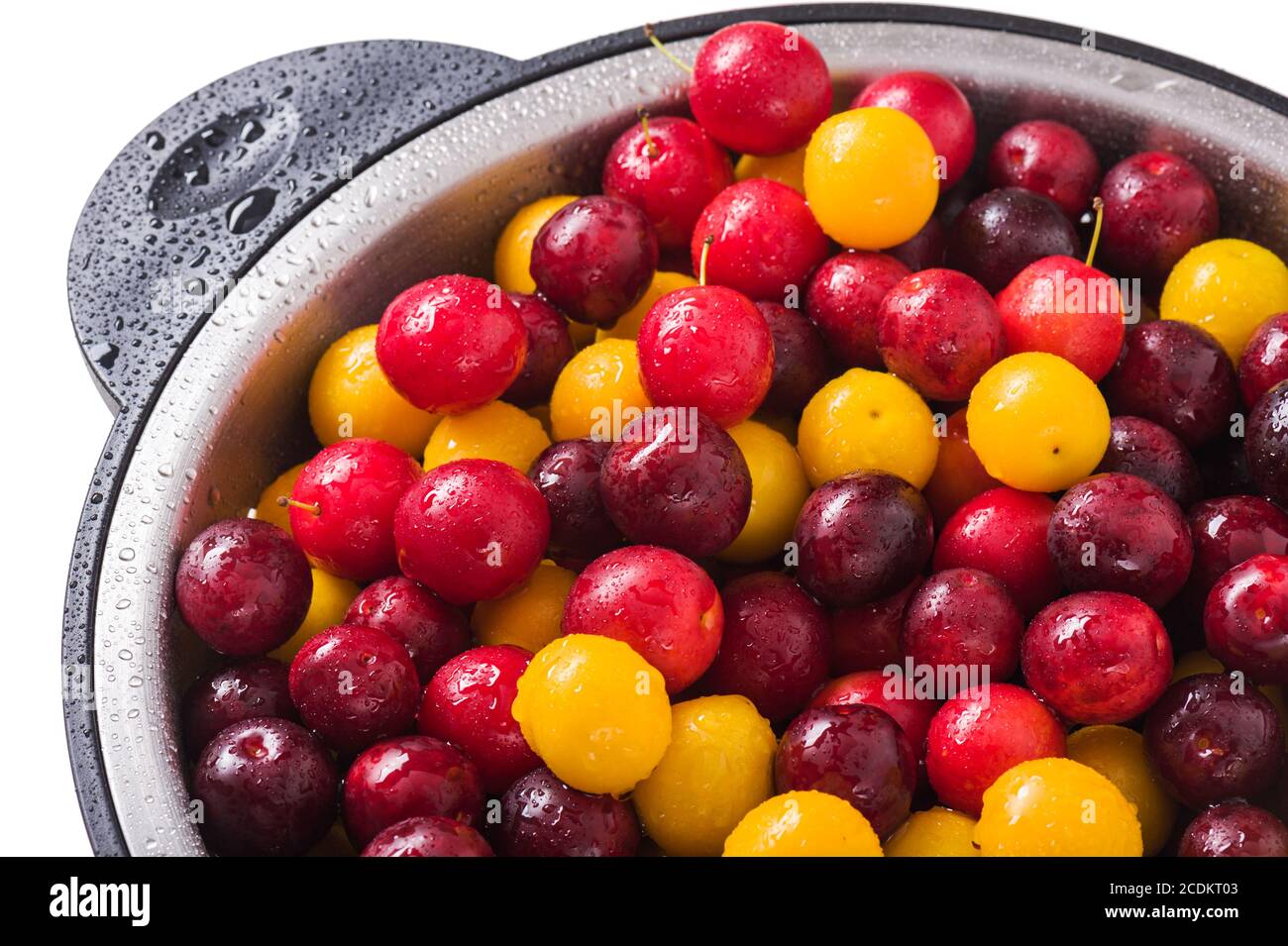Fresh plums in a colander on a white background Stock Photo