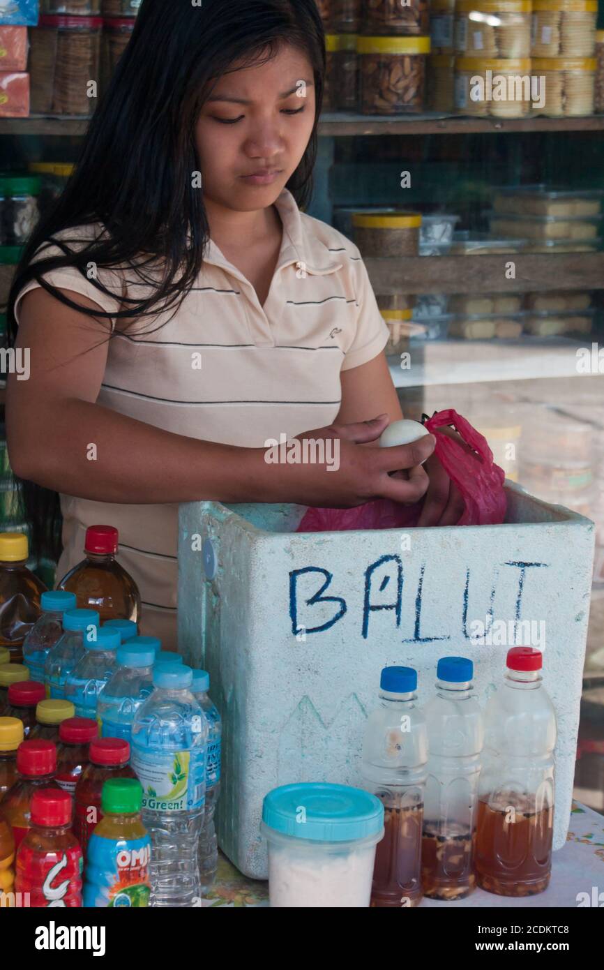 girl selling balut - breeded, cooked duck-eggs Stock Photo