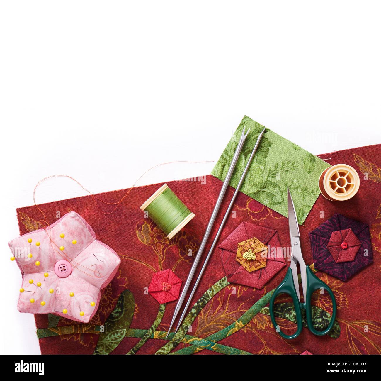 Tools for applique to fabric and detail of the quilt Stock Photo