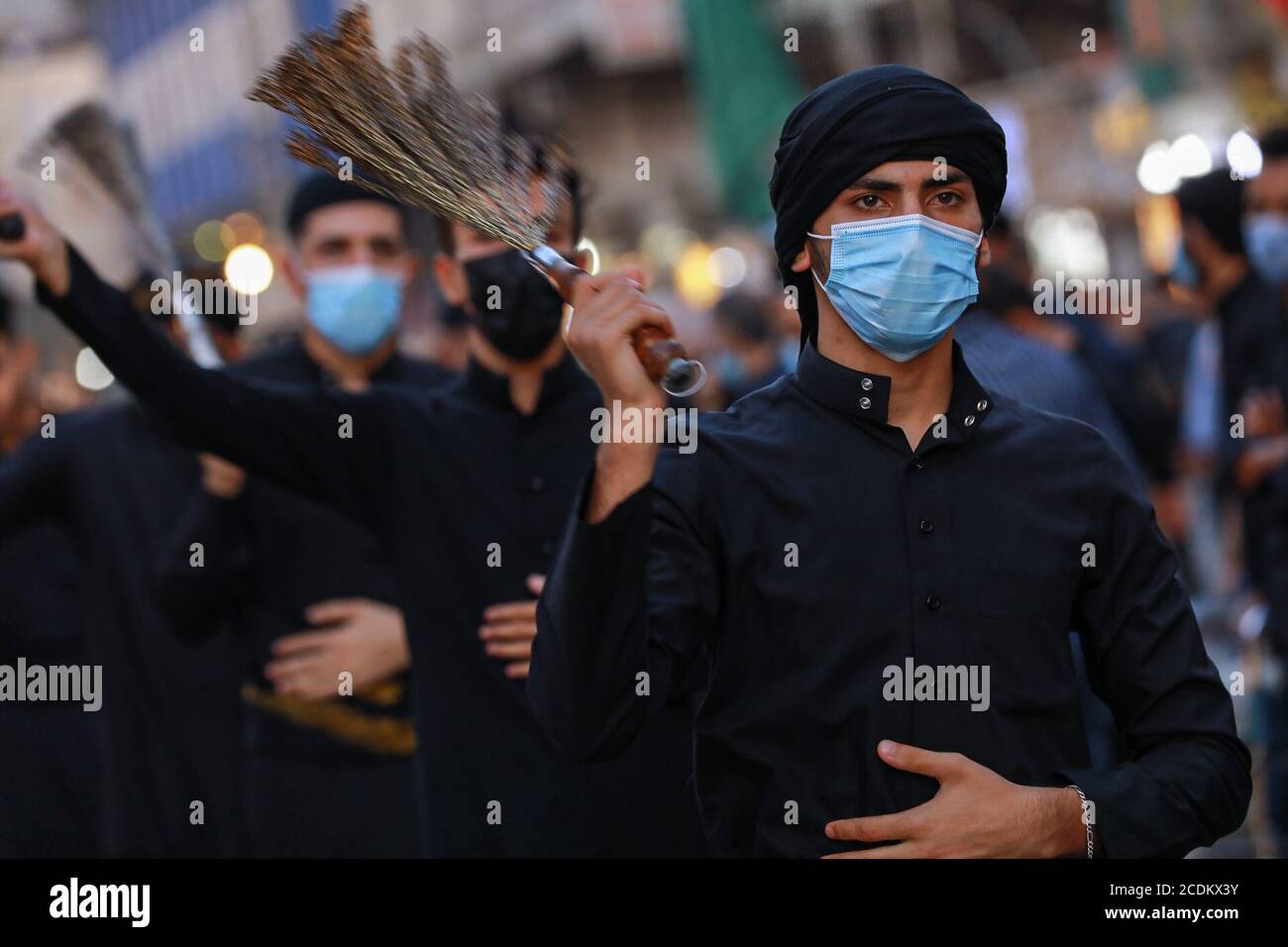 Baghdad, Iraq. 28th Aug, 2020. A Shia Muslim man, wearing a face 