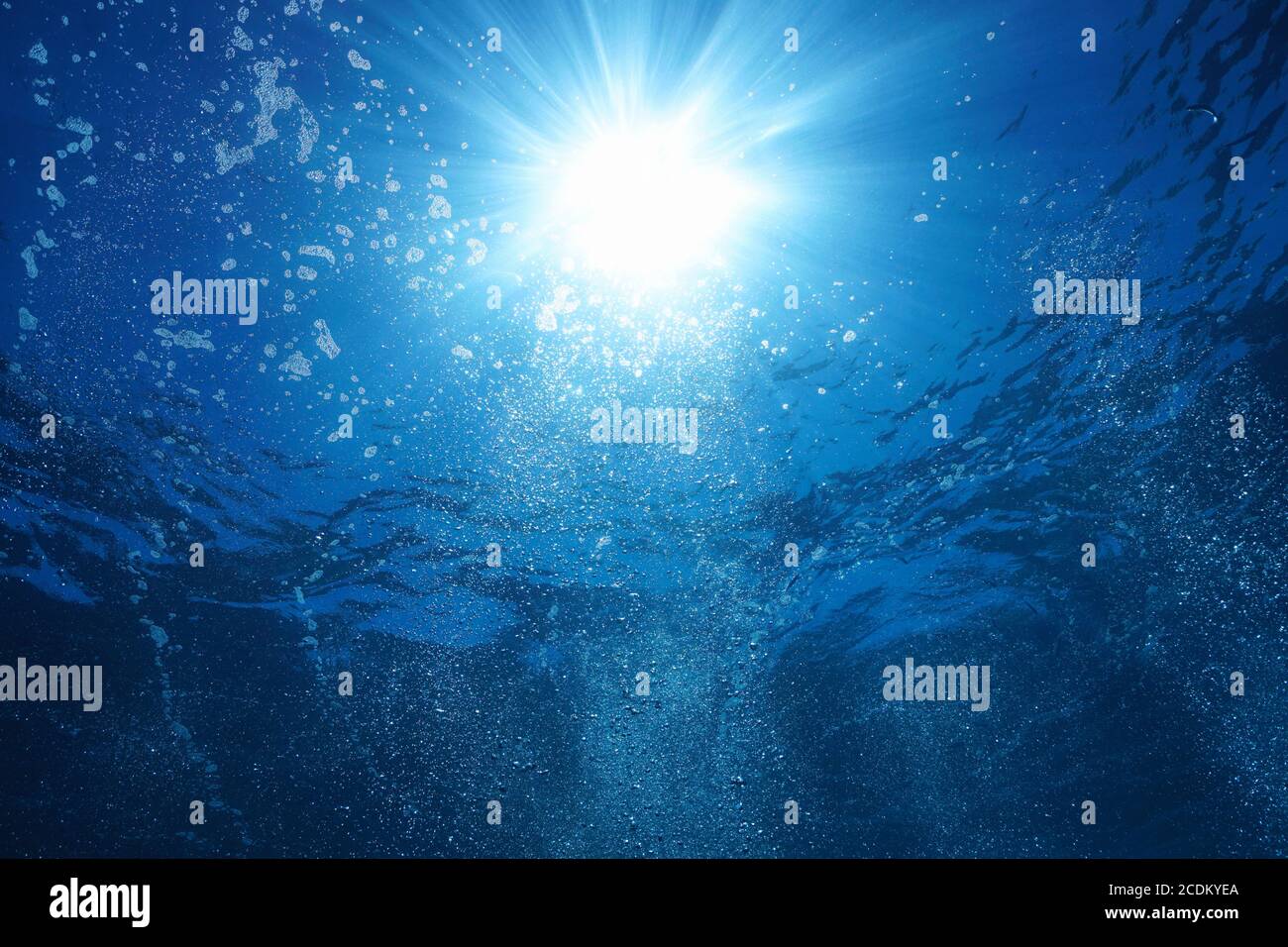 Sunshine with air bubbles underwater in the ocean, natural scene Stock Photo