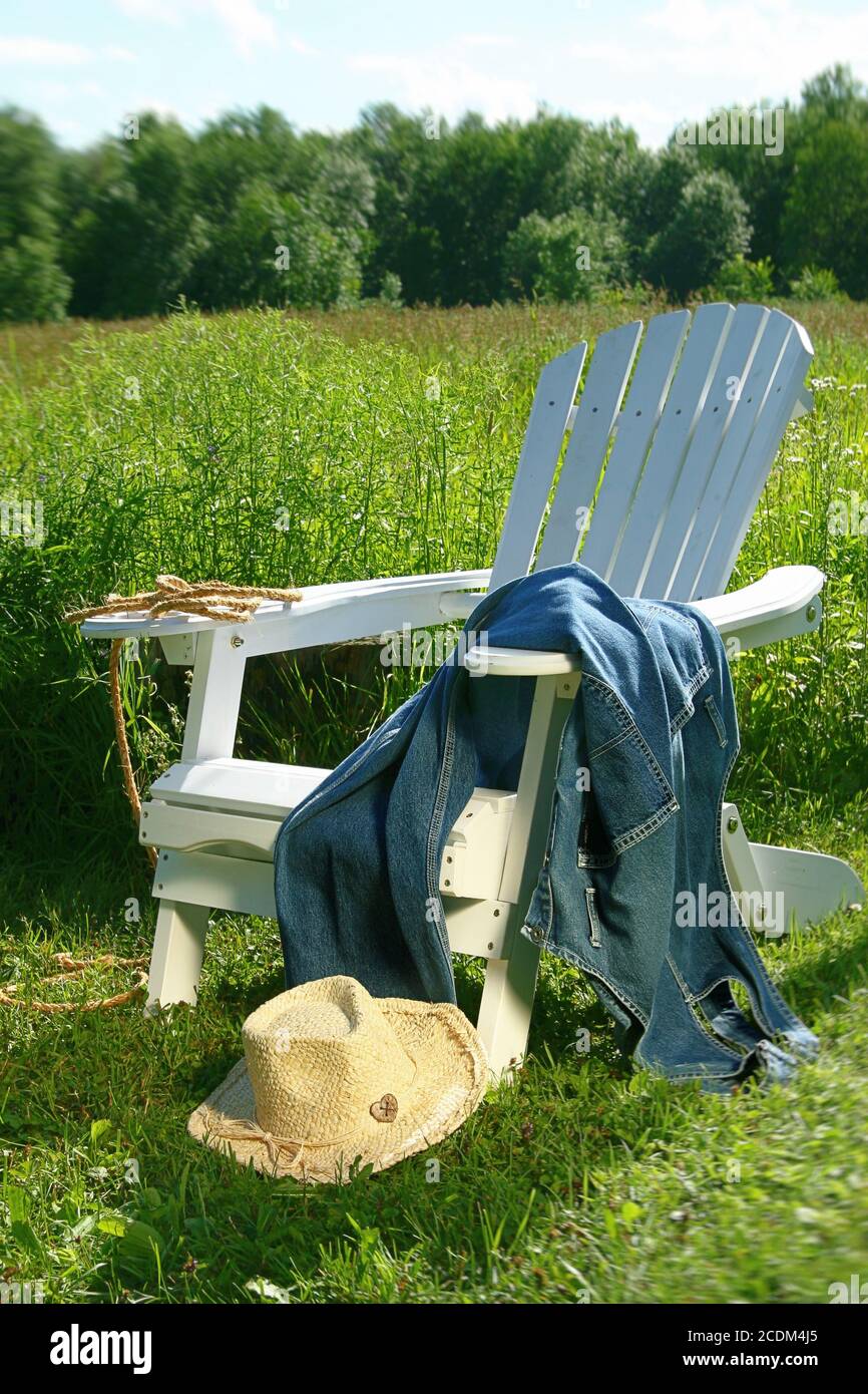 Jeans laying on chair in field Stock Photo