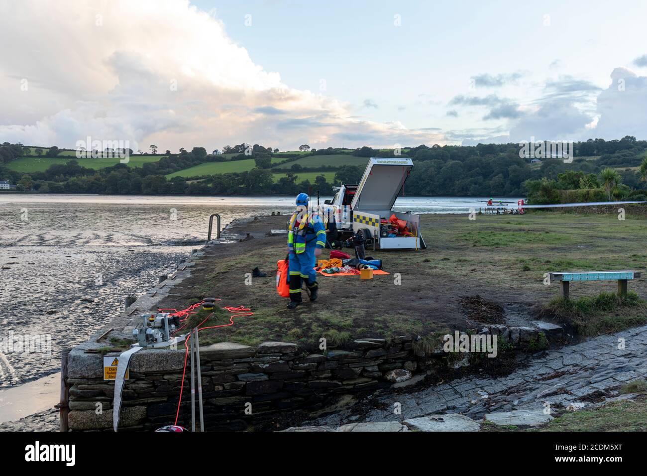 Rescue of Hire Boat boat aground in Restonguet Creek, Cornwall.  High tide is not due to float them off until 03AM and bad weather is expected. Stock Photo