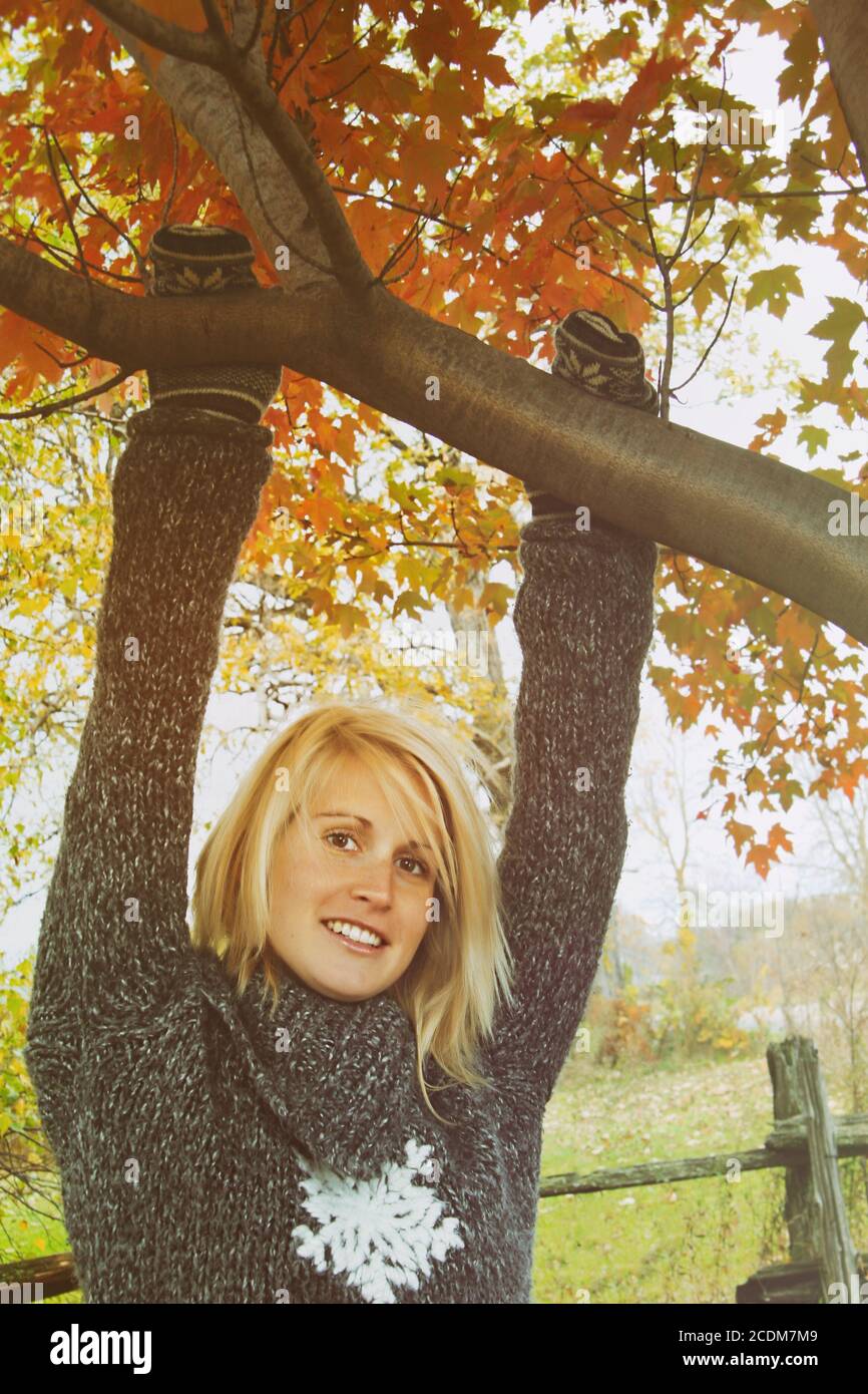 Woman hanging on branch Stock Photo