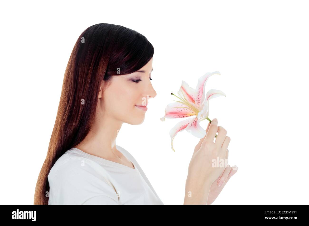 Beautiful young woman holding a white lily at face isolated over white Stock Photo