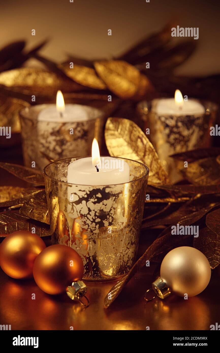 Closeup of candles lit with a sparkling gold theme Stock Photo