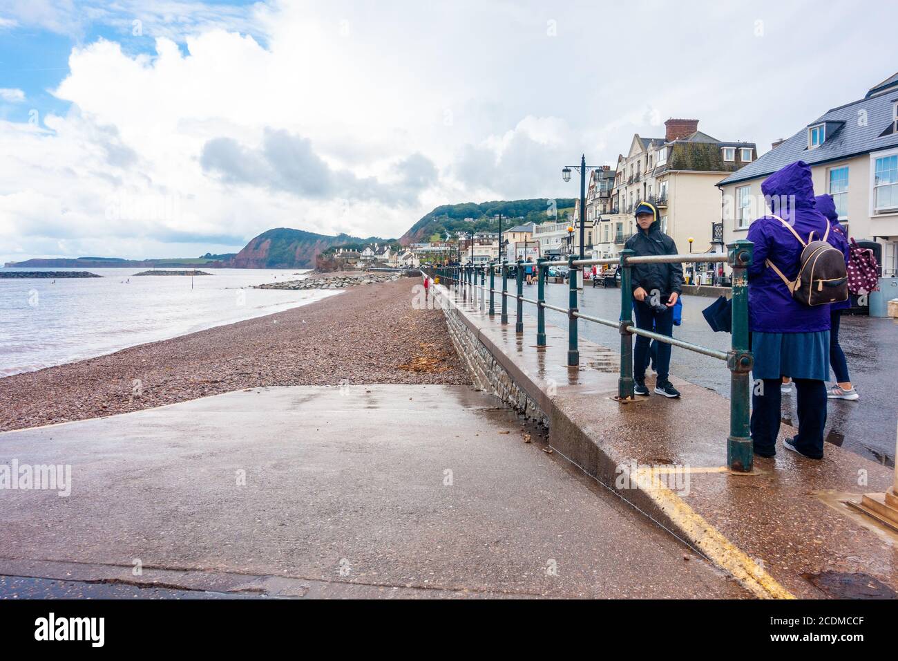 A view along Sidmouth beach in South Devon, UK on a cloudy and wet day at the end of the British summer. The beach is empty. Stock Photo