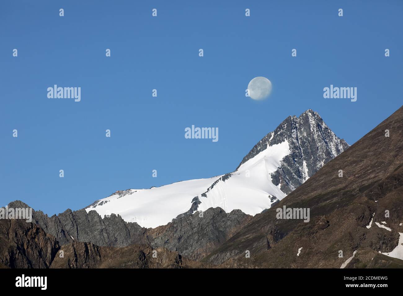 Grossglockner with setting moon, view from the Grossglockner High Alpine Road, Salzburg, Austria Stock Photo