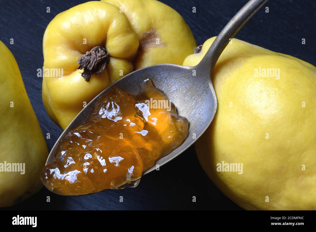 Quince jelly in spoon and quince fruit, Germany Stock Photo Alamy