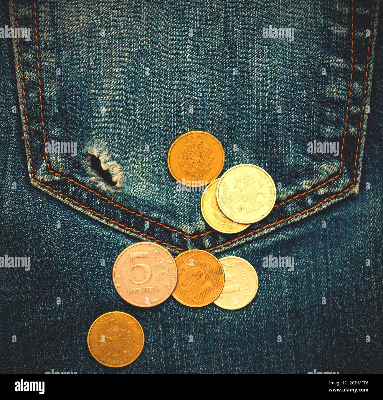 pocket with hole and coins Stock Photo