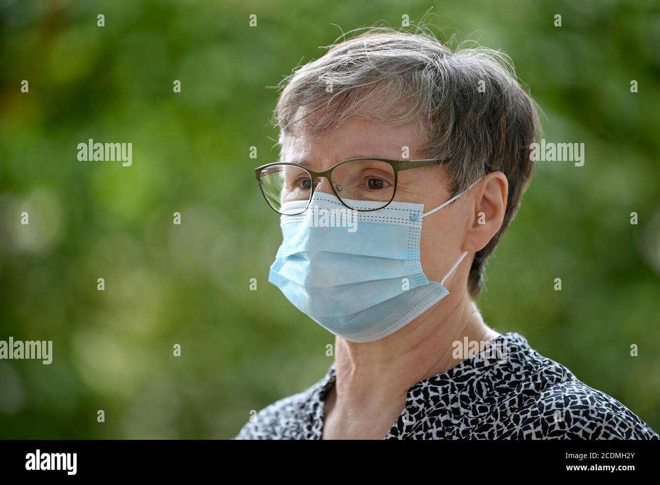 Elderly woman wears mouth mask correctly over nose and mouth, portrait, corona crisis, Germany Stock Photo