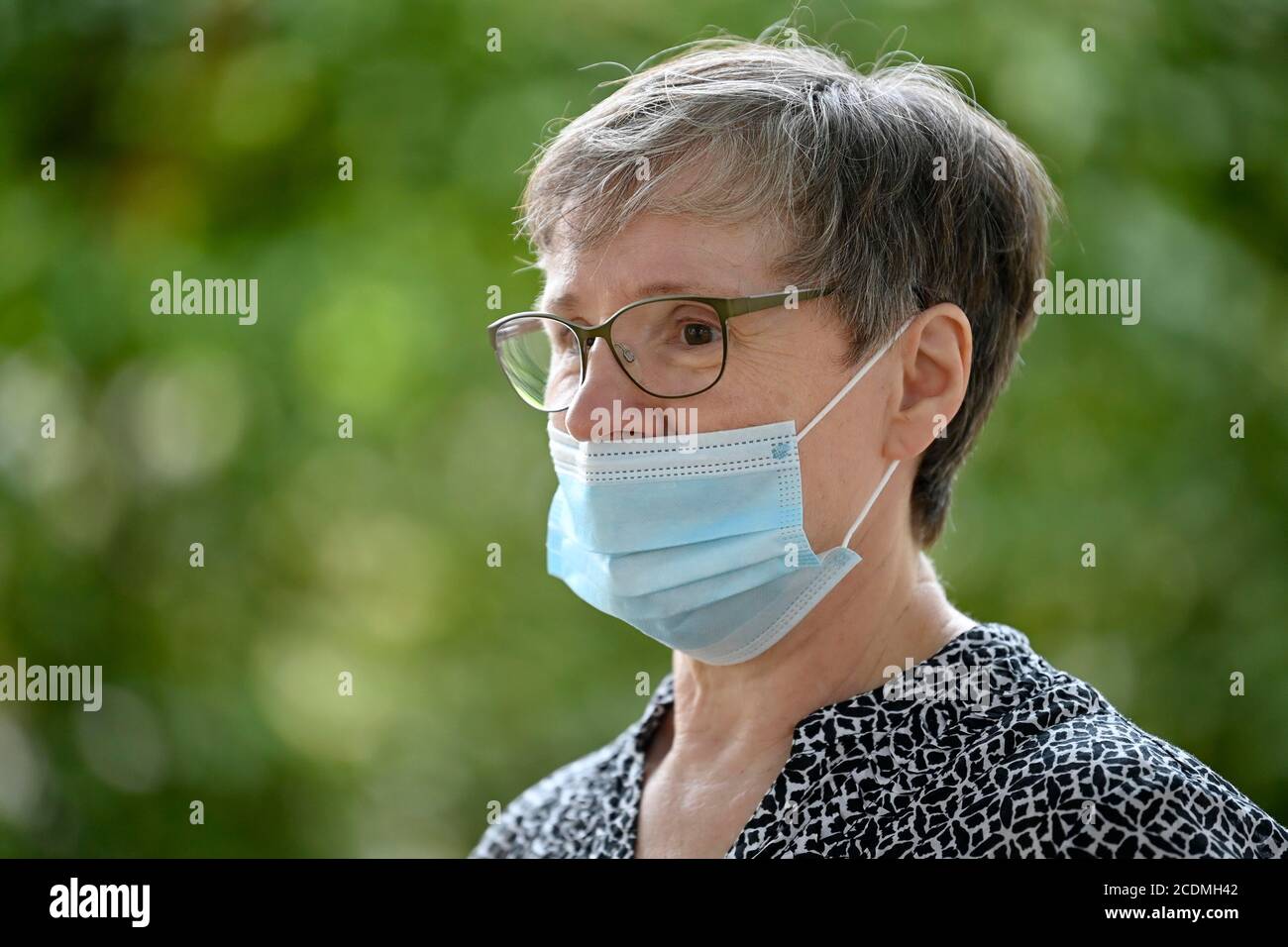 Older woman wearing a face mask under her nose, portrait, corona crisis, Germany Stock Photo