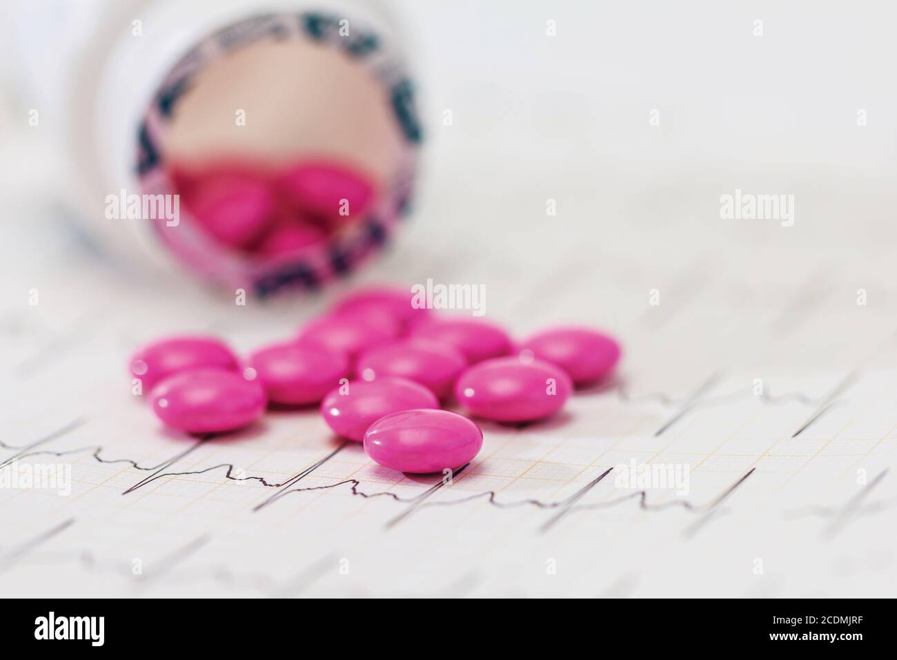 Prescription Medication Pain Pills and Drug Bottle on cardiogram Stock Photo