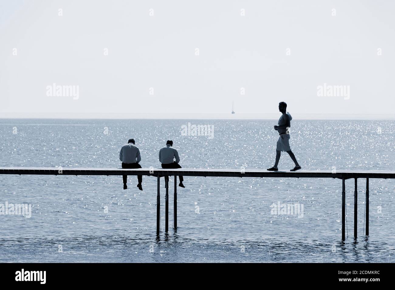 Two men are sitting, one man goes to the bathing jetty by the sea, Uendelige Bro, Infinite Bridge, Aarhus, Jutland, Denmark Stock Photo
