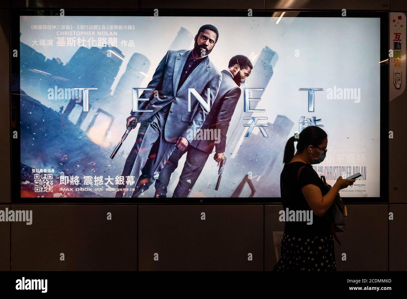 Hong Kong, China. 24th Aug, 2020. A commuter walks past a poster of Christopher Nolan's blockbuster film Tenet at MTR subway station in Hong Kong. Credit: Budrul Chukrut/SOPA Images/ZUMA Wire/Alamy Live News Stock Photo