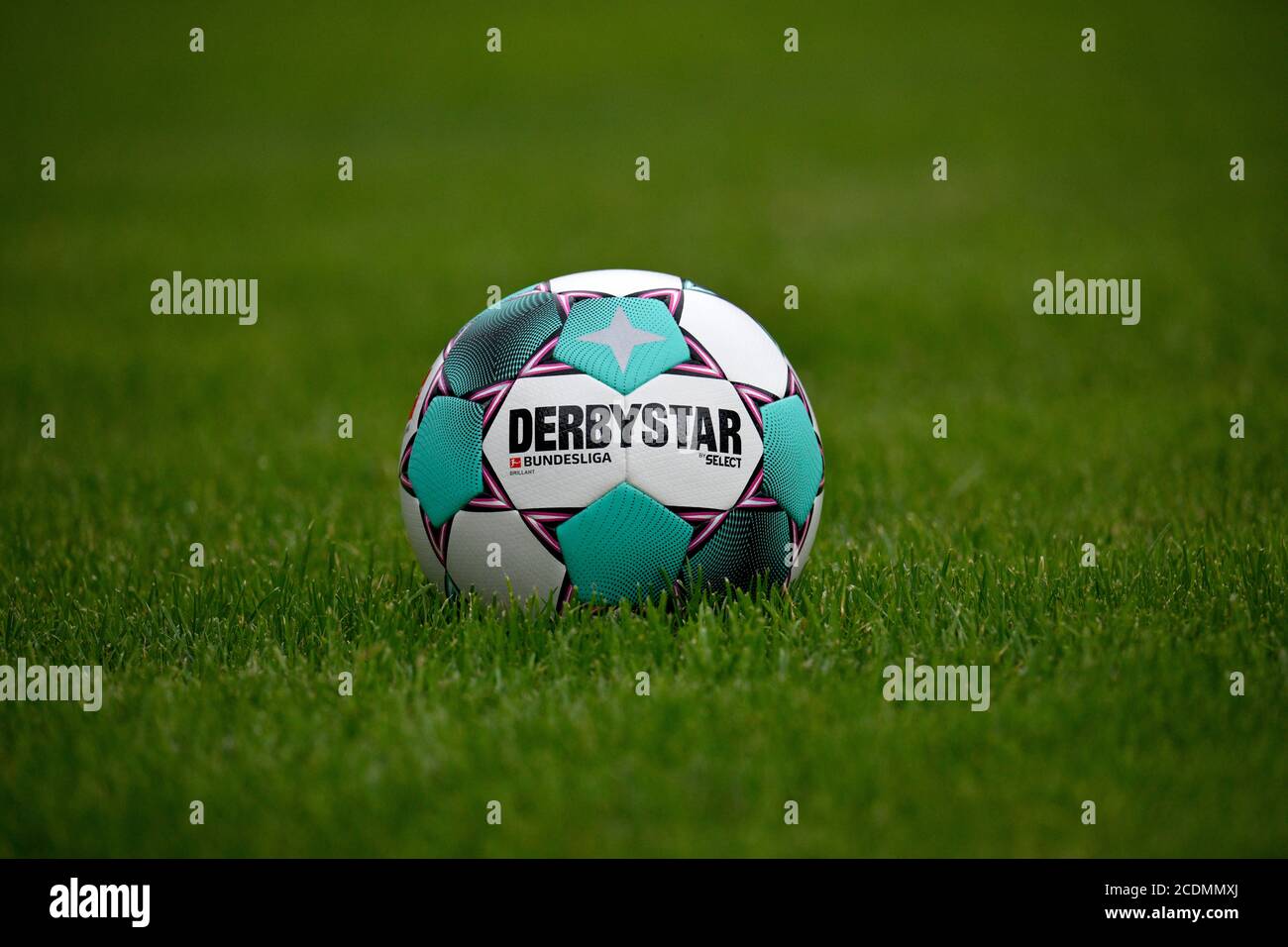 Adidas Derby star Brillant APS 20/21, match ball of the 2020/2021 Bundesliga season in turquoise and purple, lies on grass, Germany Stock Photo