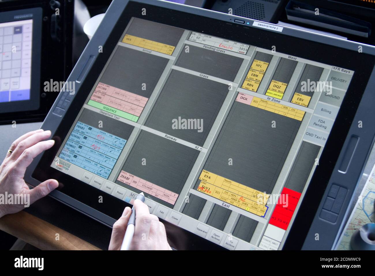 Digital flight progress strips, seen on an air traffic controller's strip board in an airport control tower Stock Photo