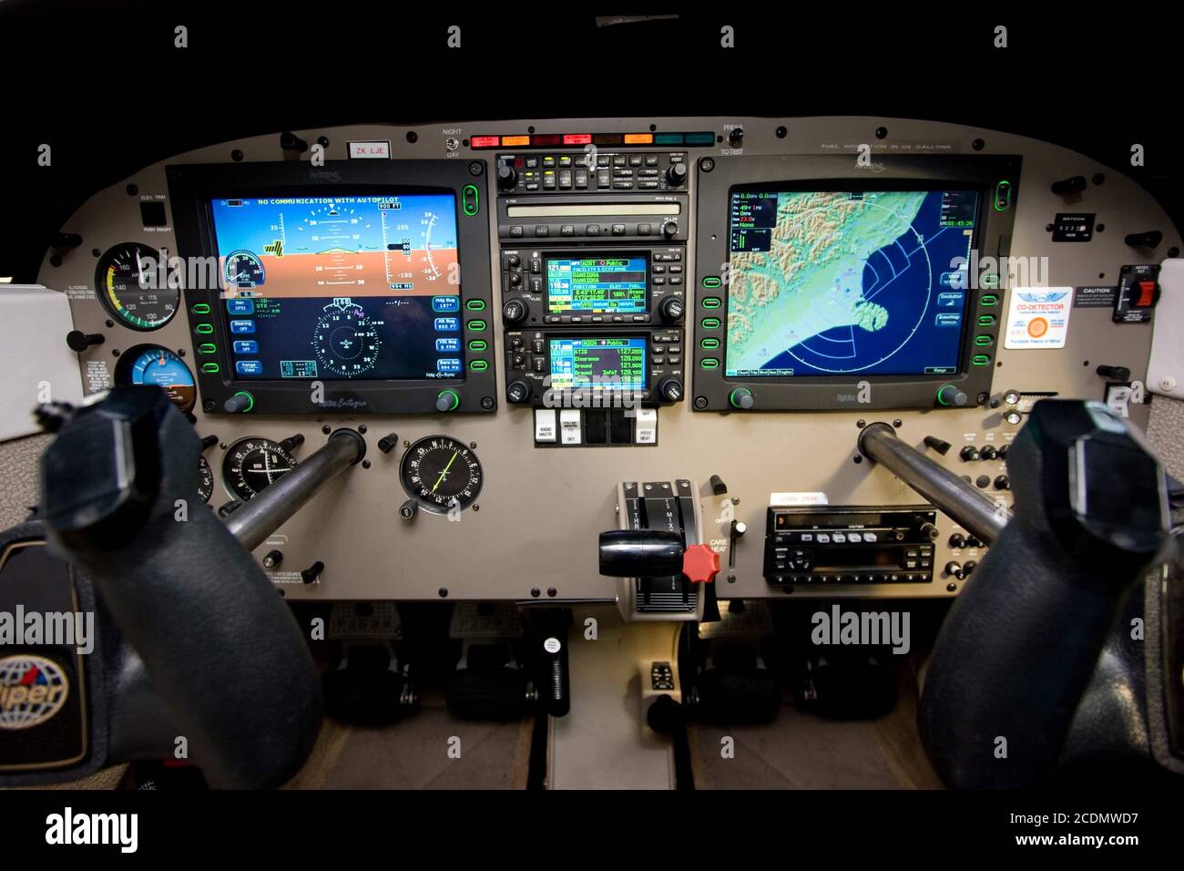The glass (digital) cockpit and flight controls of a Piper PA-28-181 Archer III. An Avidyne FlightMax avionics display system is installed Stock Photo