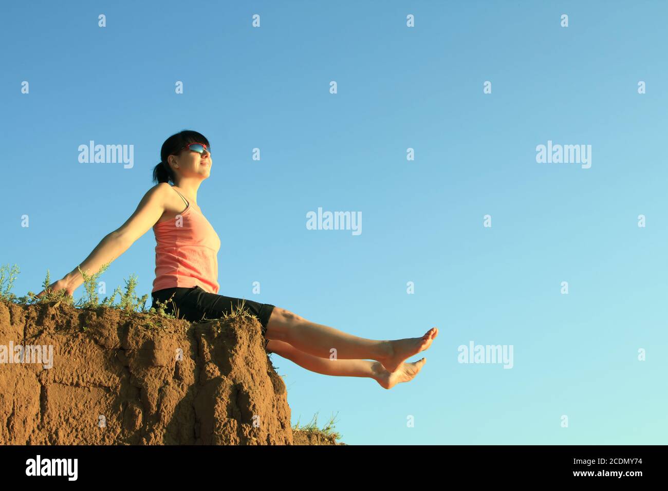 Girl sitting on high hill hi-res stock photography and images - Alamy