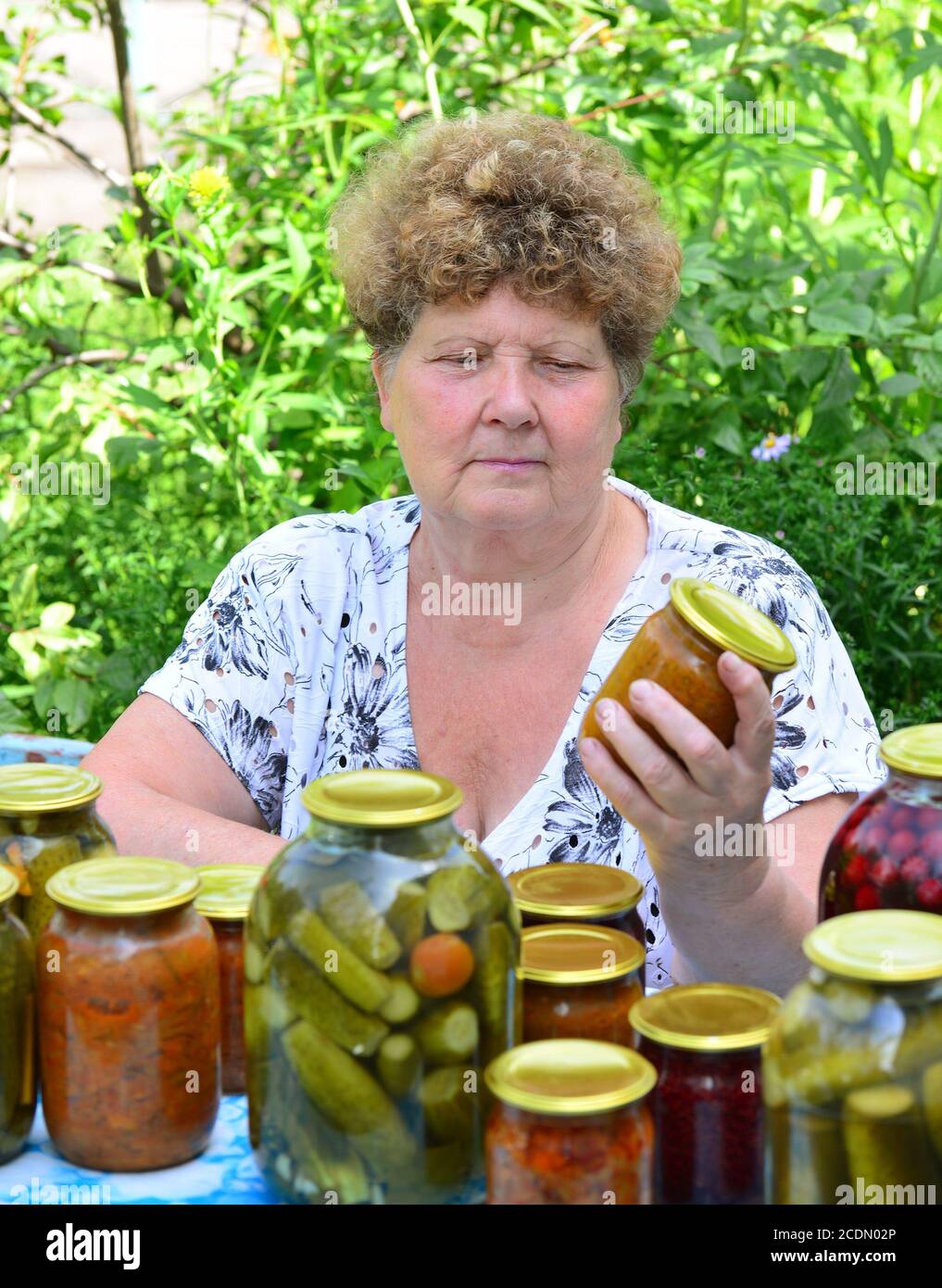 Mature housewife with canned food for the winter Stock Photo