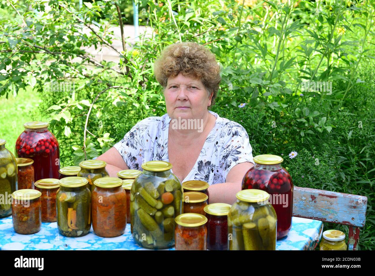 Mature housewife with canned food for the winter Stock Photo