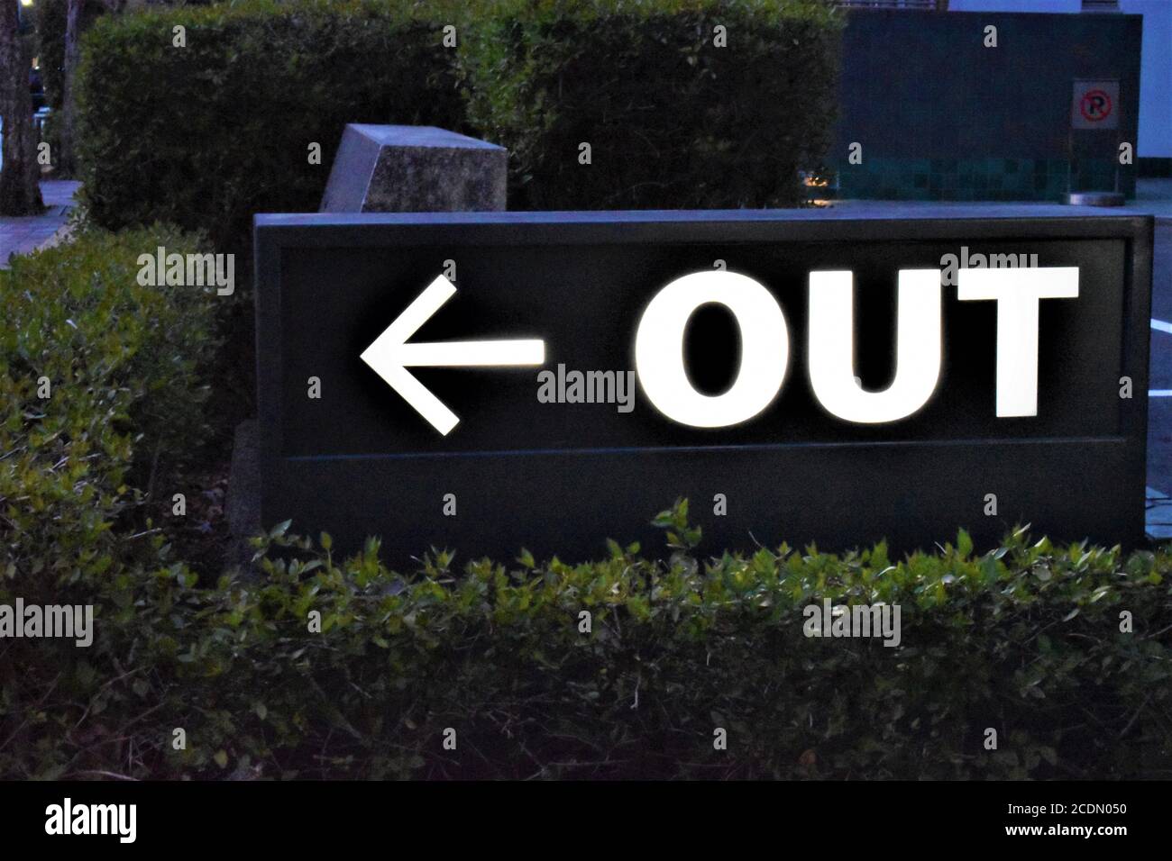 A lighted signage that says Out points towards the exit of a parking ...