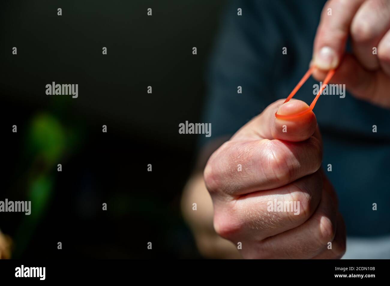 Pulling rubber band with hand hires stock photography and images Alamy