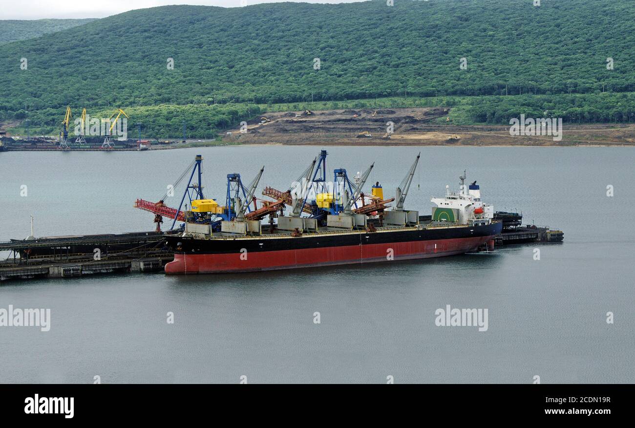 Vessel under loading Stock Photo - Alamy