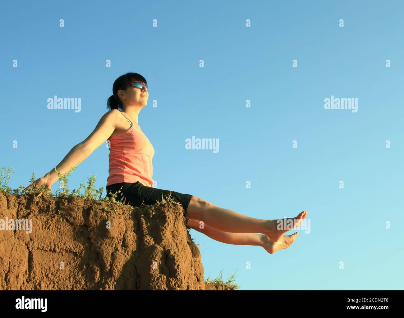 Girl Sitting On Edge Cliff High Resolution Stock Photography and Images