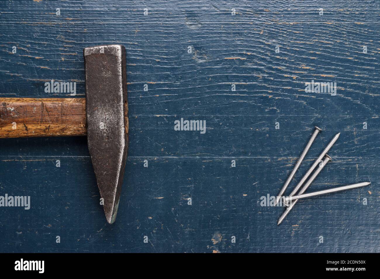 old hammer and nails on blue table Stock Photo