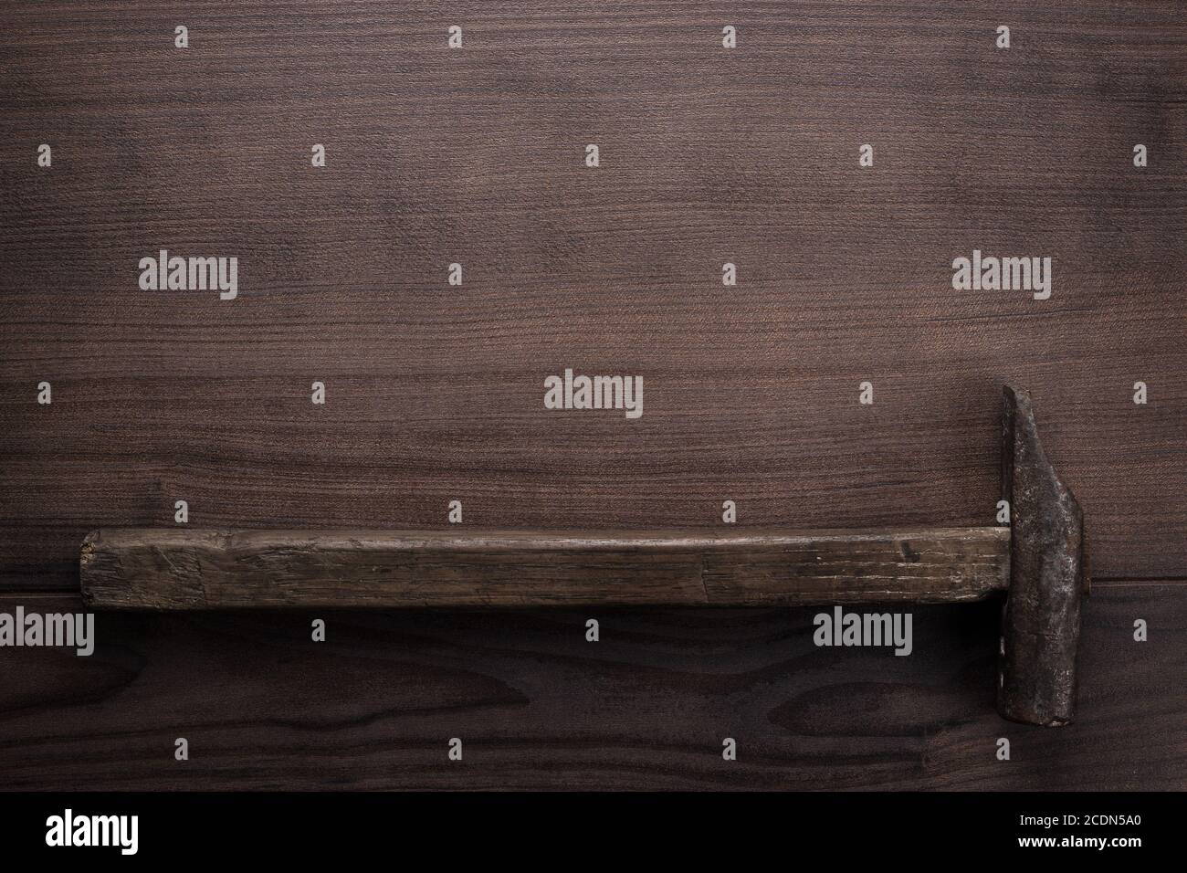 old rusty hammer on wooden background Stock Photo