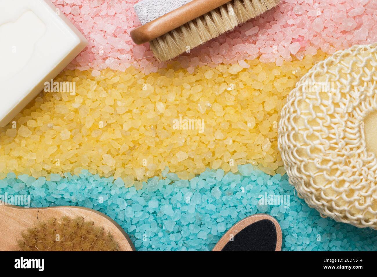 pink blue yellow bath salt and bath accessories Stock Photo