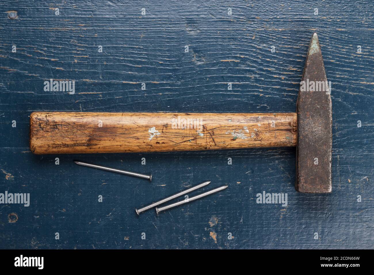 old hammer and nails on blue table Stock Photo