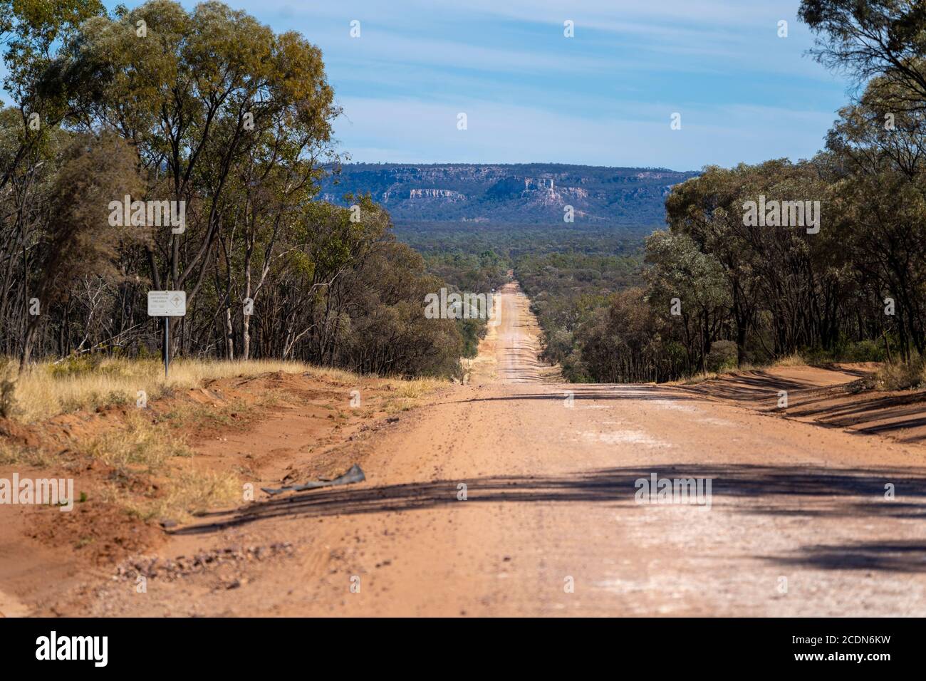 Straight dirt road with sandstone escarpment in the distance. Salvator Rosa Section Carnarvon