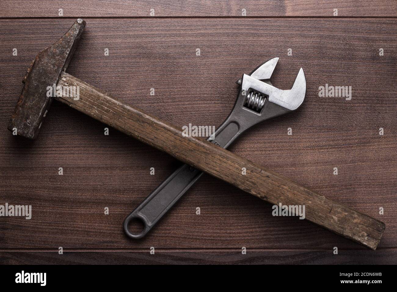 old rusty hammer and wrench on the table Stock Photo