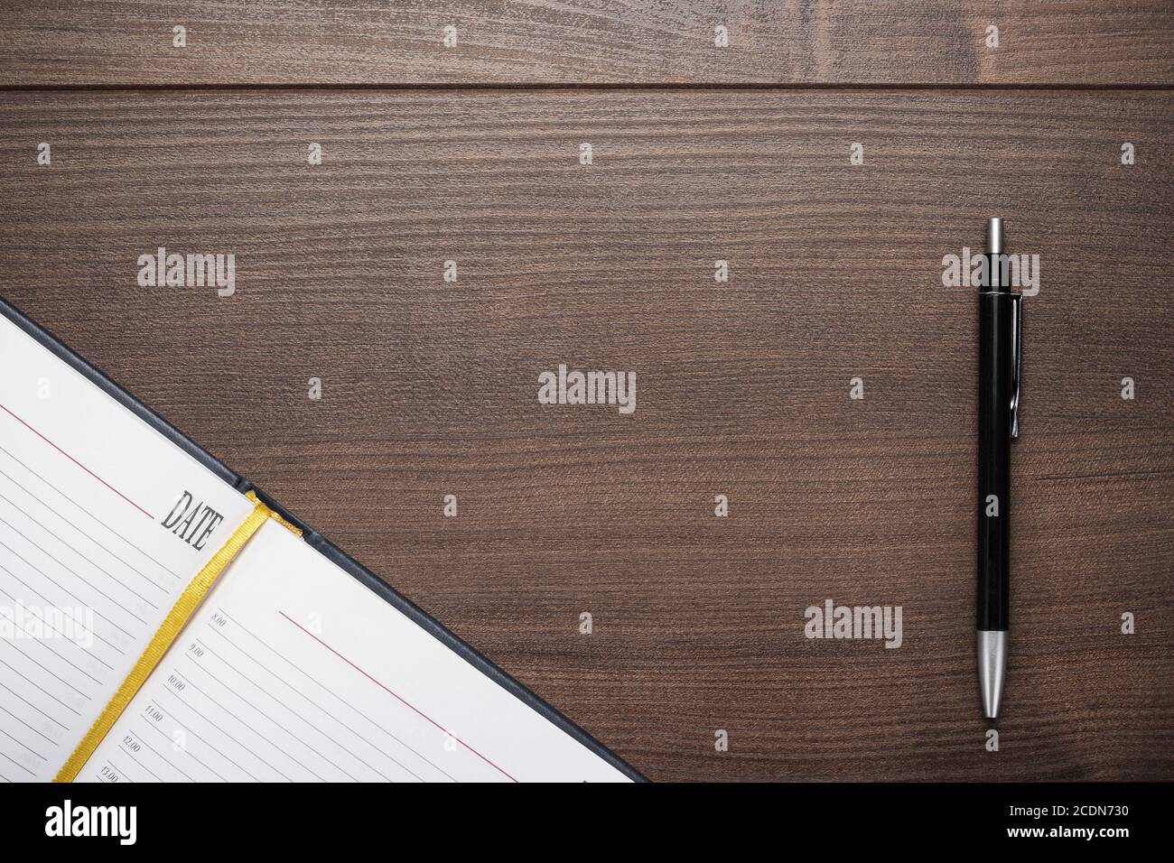 opened notebook and pen on wooden table Stock Photo
