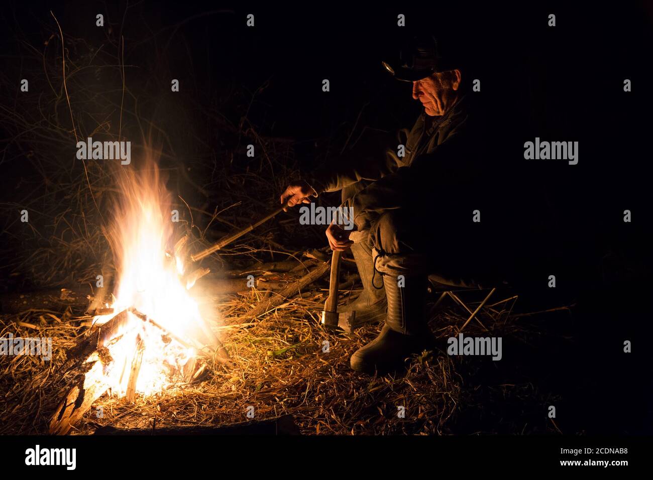 Man around the campfire Stock Photo