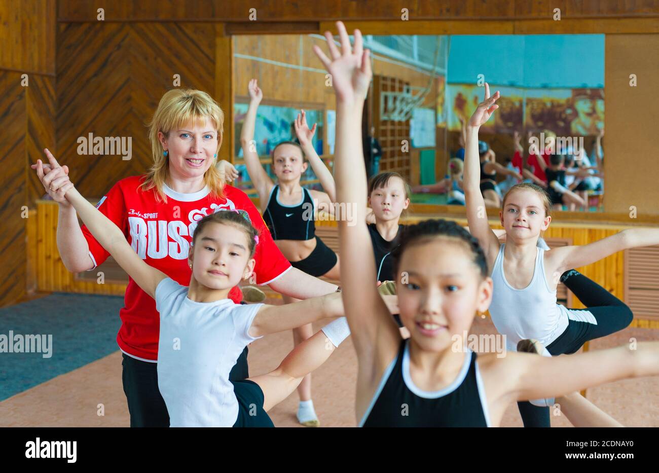 Russian trainer coaches schoolgirls gymnasts Stock Photo