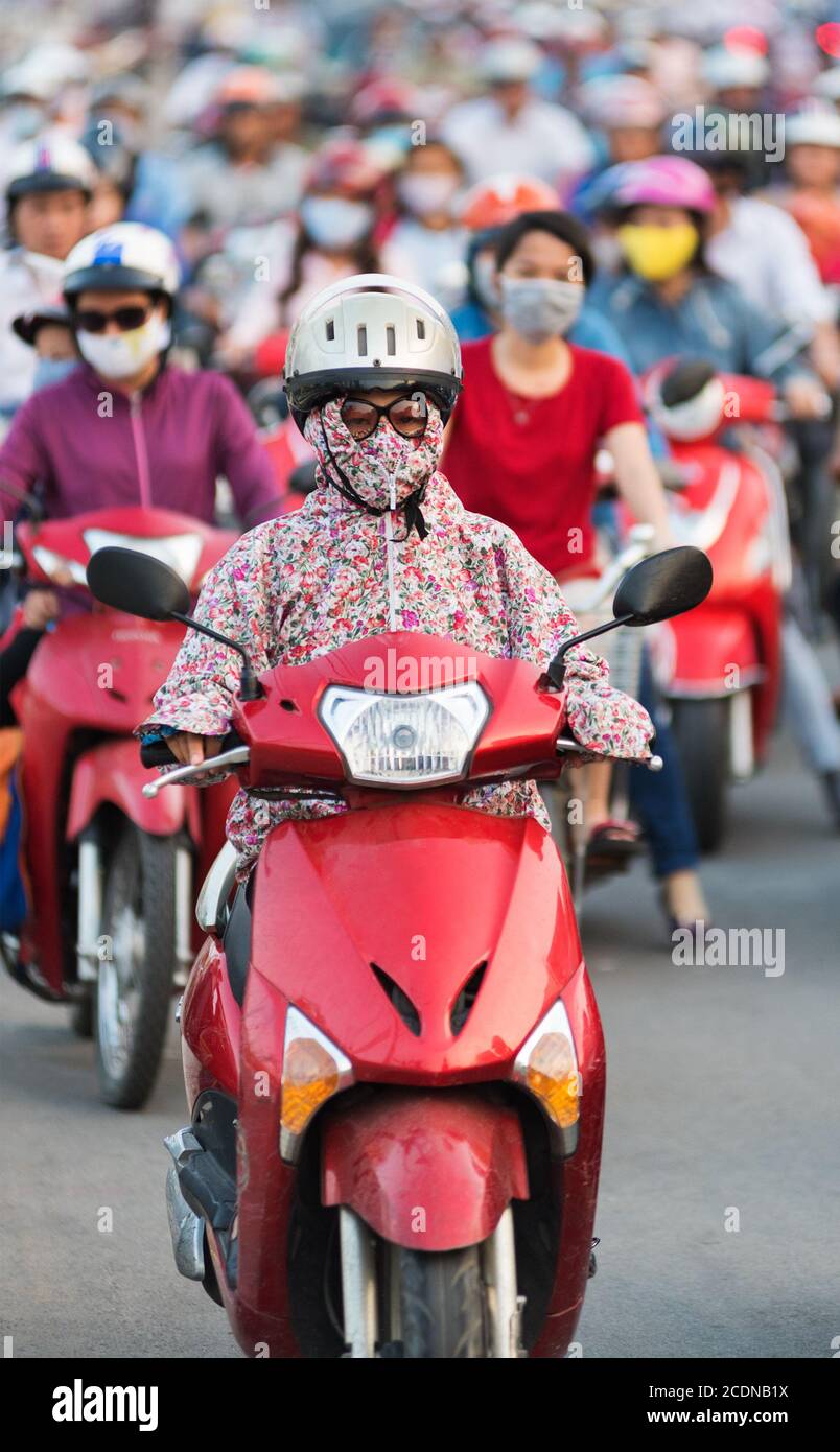 muffled motorcyclist in traffic jam, Vietnam Stock Photo