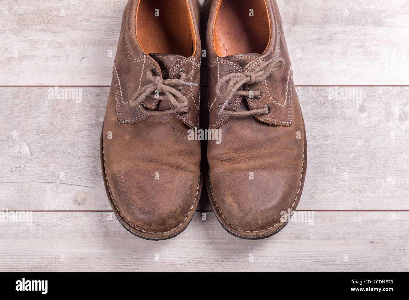 Brown men#39;s shoes on a wooden background Stock Photo