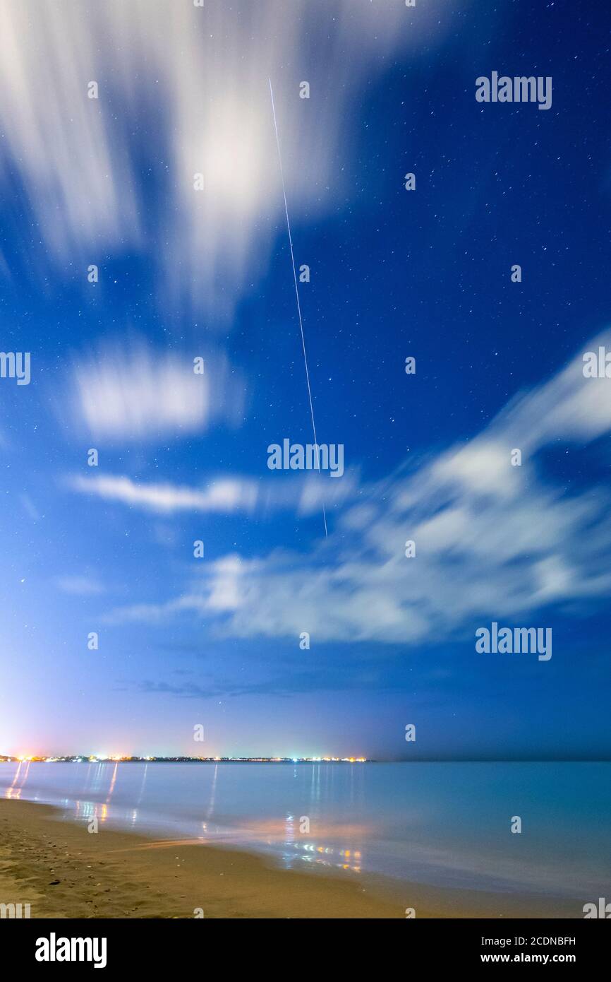 Trail of International Space Station in night sky as it passes over Hervey bay Queensland Australia Stock Photo
