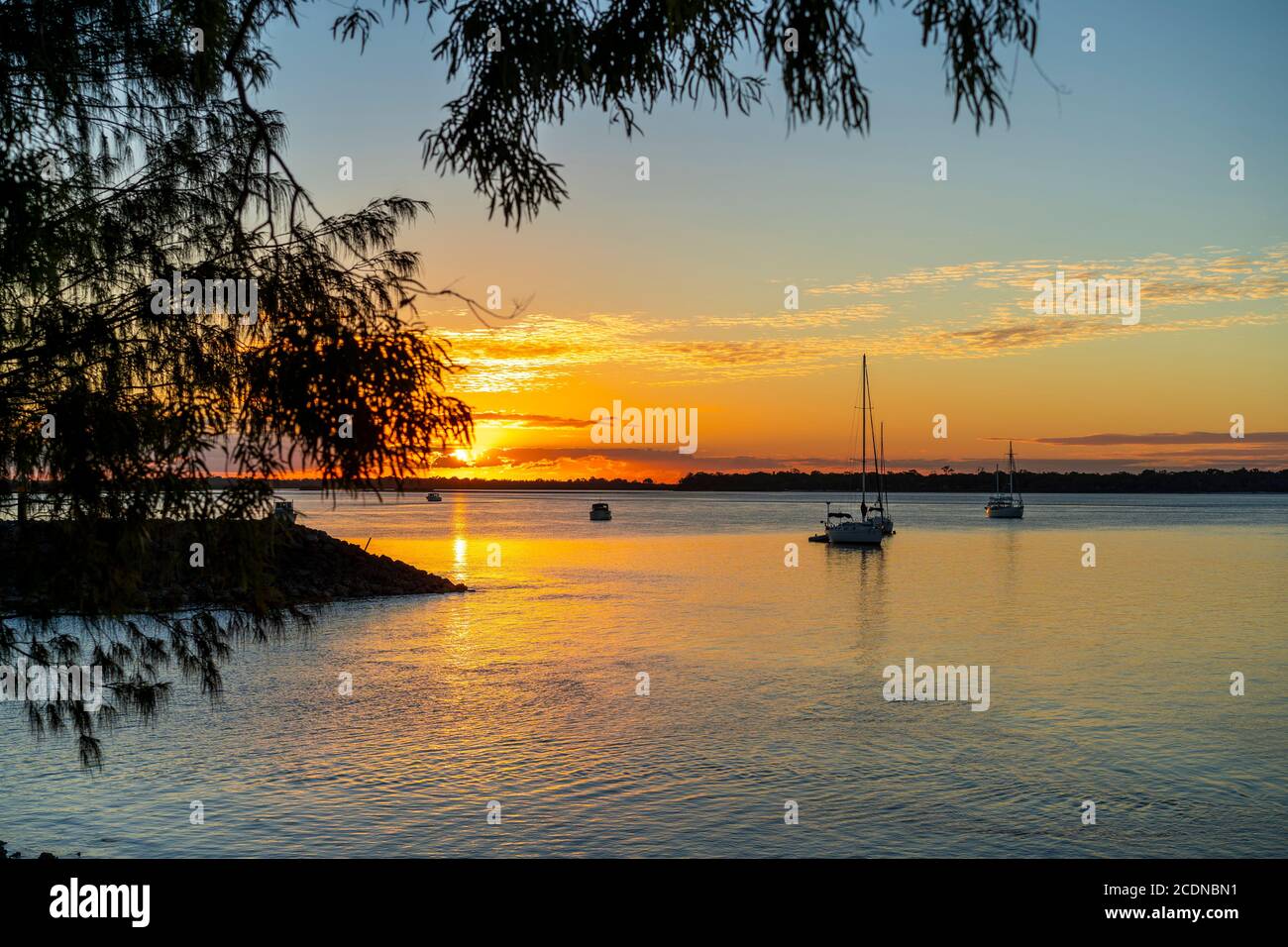 Boats anchored in Burrum river at sunset, Burrum Heads, Queensland